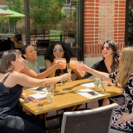 Women clinking glasses at brunch